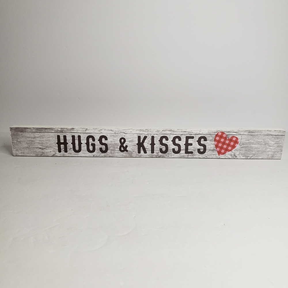 Rectangular wooden sign with the phrase "HUGS & KISSES". 209